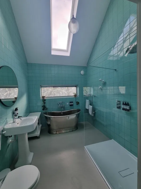 Beach house bathroom with freestanding steel bath