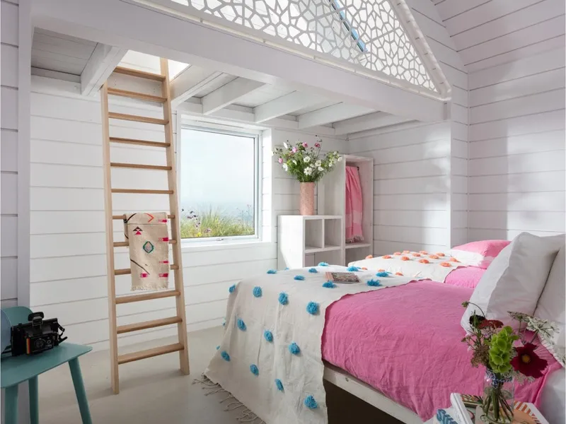 Beach house bedroom in white timber